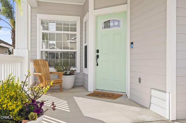 view of exterior entry with a porch