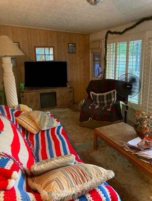 carpeted living room with wood walls