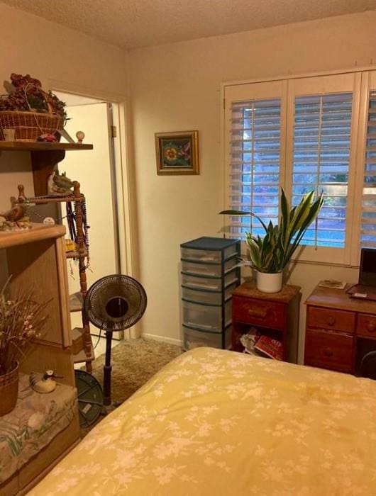 bedroom with carpet and a textured ceiling