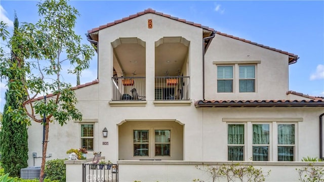 rear view of property with a balcony and central AC unit