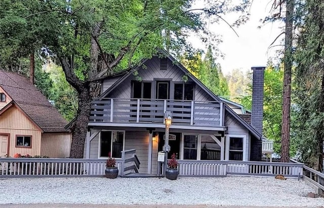 back of house featuring a wooden deck