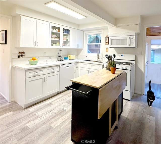 kitchen featuring glass insert cabinets, white appliances, white cabinets, and light wood finished floors