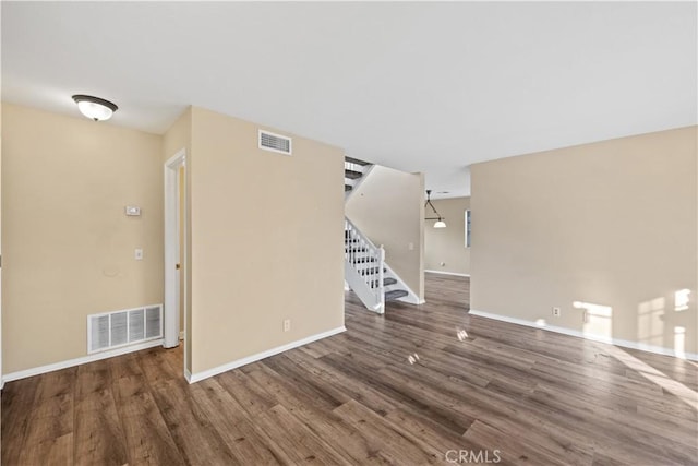 30340 Channel Way Dr, Canyon Lake, CA 92587 - unfurnished living room featuring baseboards, visible vents, wood finished floors, and stairway