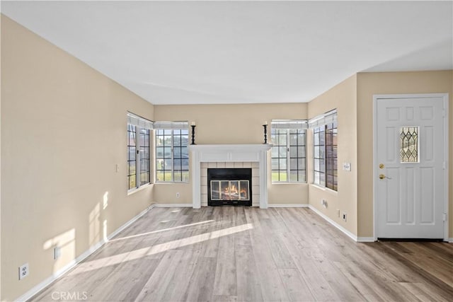 30340 Channel Way Dr, Canyon Lake, CA 92587 - unfurnished living room featuring baseboards, wood finished floors, and a tile fireplace