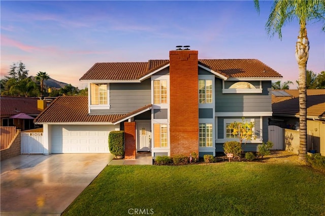 view of front of home with a garage and a yard