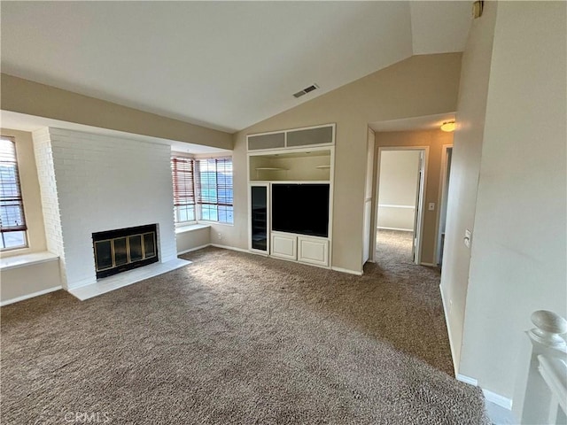 unfurnished living room with visible vents, a fireplace, built in features, carpet floors, and vaulted ceiling