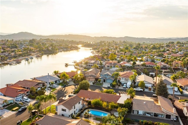 drone / aerial view featuring a water and mountain view