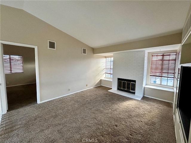 30340 Channel Way Dr, Canyon Lake, CA 92587 - unfurnished living room featuring carpet flooring, vaulted ceiling, visible vents, and a fireplace