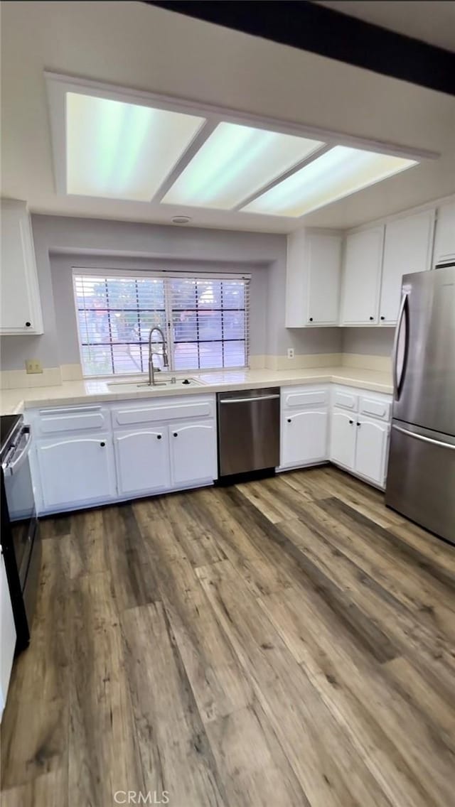 30340 Channel Way Dr, Canyon Lake, CA 92587 - kitchen featuring a sink, appliances with stainless steel finishes, white cabinets, and light countertops