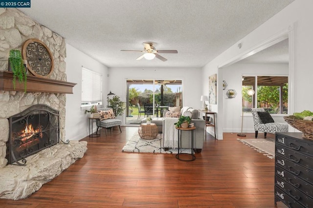 living room featuring dark hardwood / wood-style flooring, a wealth of natural light, and a fireplace