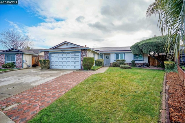 ranch-style house with a garage, a front yard, and solar panels