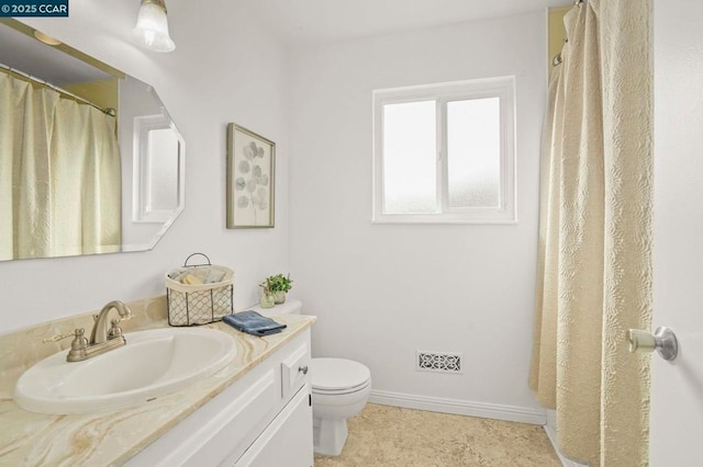 bathroom with vanity and toilet