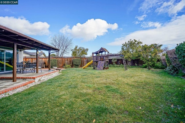 view of yard with a patio area and a playground