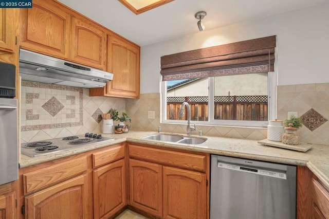 kitchen with appliances with stainless steel finishes, sink, and decorative backsplash