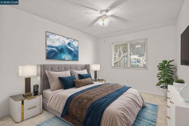 carpeted bedroom featuring ceiling fan and a textured ceiling