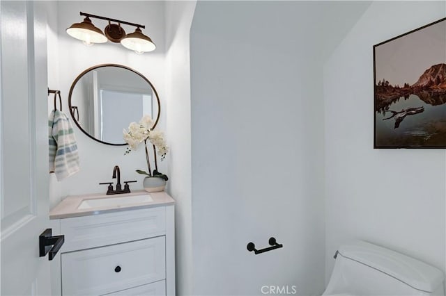 bathroom featuring vanity and toilet