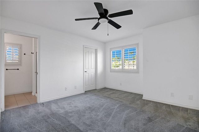 unfurnished bedroom featuring light carpet and ceiling fan