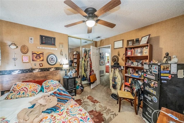 bedroom with ceiling fan, a closet, and a textured ceiling