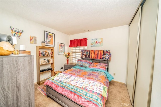 carpeted bedroom featuring a textured ceiling