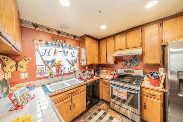 kitchen with sink, tile counters, and appliances with stainless steel finishes