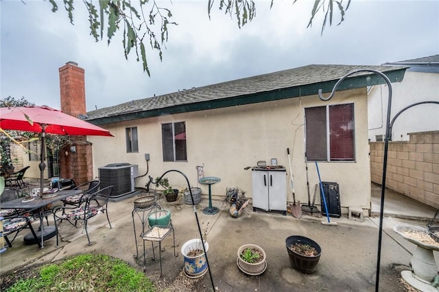 rear view of property featuring a patio area and central air condition unit