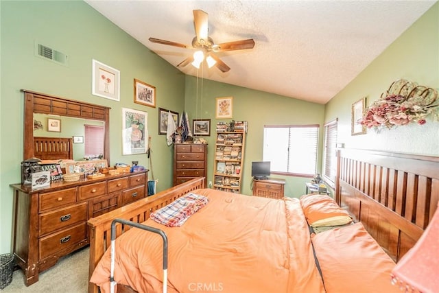 carpeted bedroom with vaulted ceiling, a textured ceiling, and ceiling fan