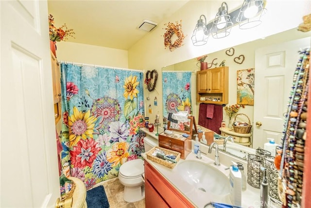 bathroom with walk in shower, vanity, and toilet