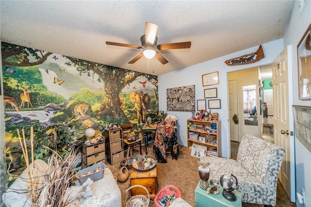 interior space with ceiling fan, a textured ceiling, and carpet flooring