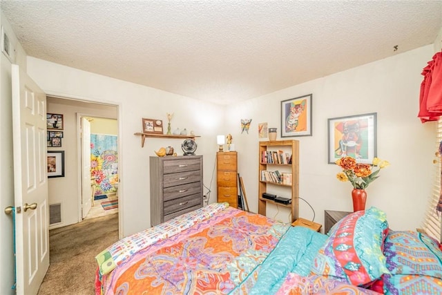 bedroom featuring light colored carpet and a textured ceiling