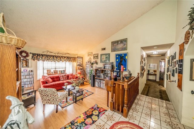 living room with high vaulted ceiling and light wood-type flooring