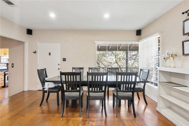 dining space featuring visible vents and wood finished floors