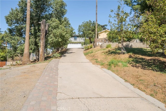 view of road with concrete driveway