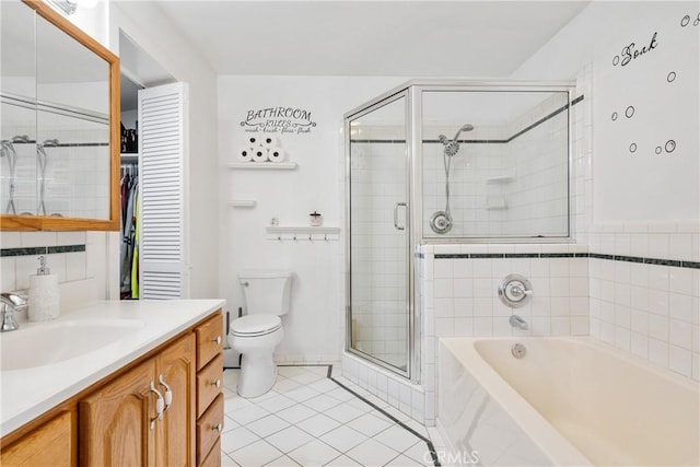 full bathroom with toilet, a stall shower, vanity, tile patterned flooring, and a bath