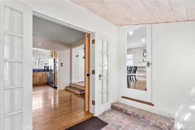 interior space with brick floor and wood ceiling