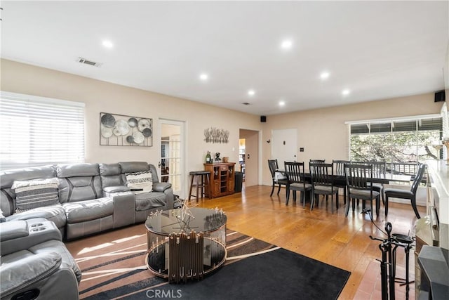 living area featuring light wood-style flooring, visible vents, and recessed lighting