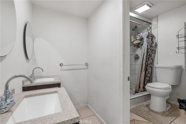 bathroom with a stall shower, a sink, and toilet