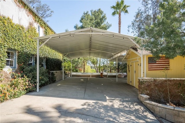 view of parking with a carport and concrete driveway