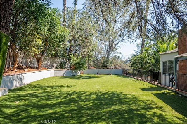 view of yard with a fenced backyard