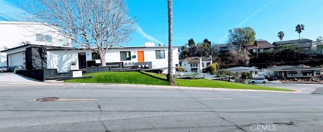 view of front of house featuring a front yard and a residential view