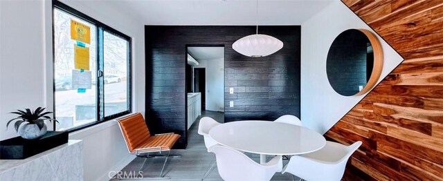 bathroom with baseboards, a soaking tub, and an accent wall