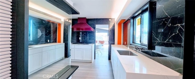 interior space featuring a sink and light wood finished floors