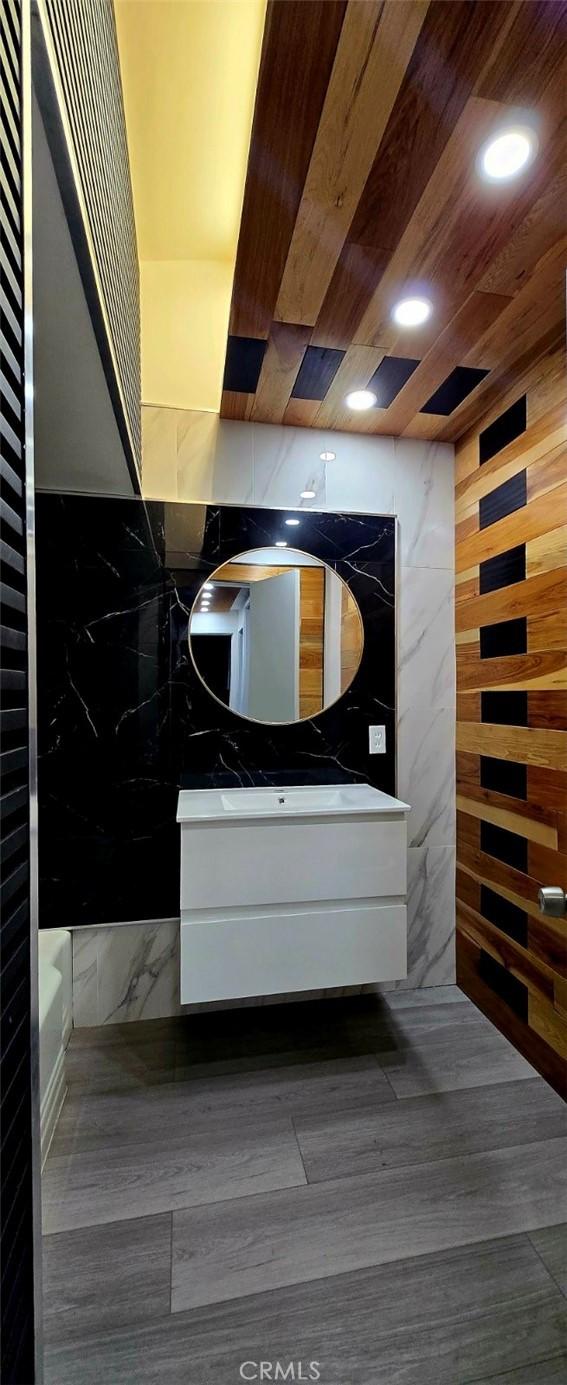 full bathroom with vanity, wood ceiling, recessed lighting, and wood finished floors