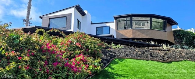 exterior space featuring a yard and stucco siding