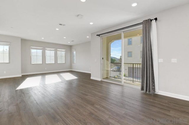 spare room with dark wood-type flooring