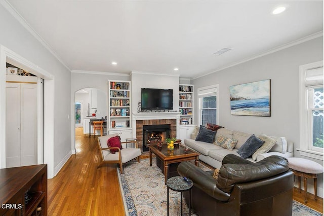 living room with ornamental molding and hardwood / wood-style floors