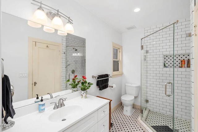 bathroom with vanity, tile patterned flooring, a shower with door, and toilet