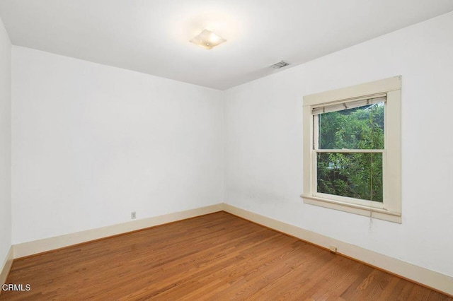 empty room with hardwood / wood-style flooring