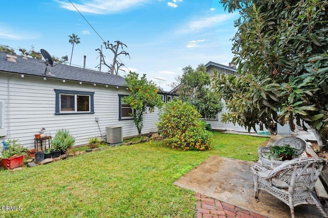 view of yard with central AC and a patio area