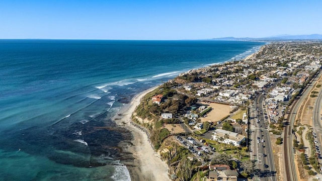 birds eye view of property featuring a beach view and a water view