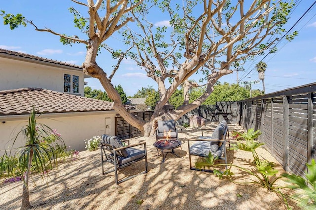 view of patio / terrace with a fire pit and fence
